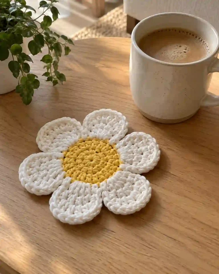 Crochet Flower Coaster Pattern with six white petals and yellow center