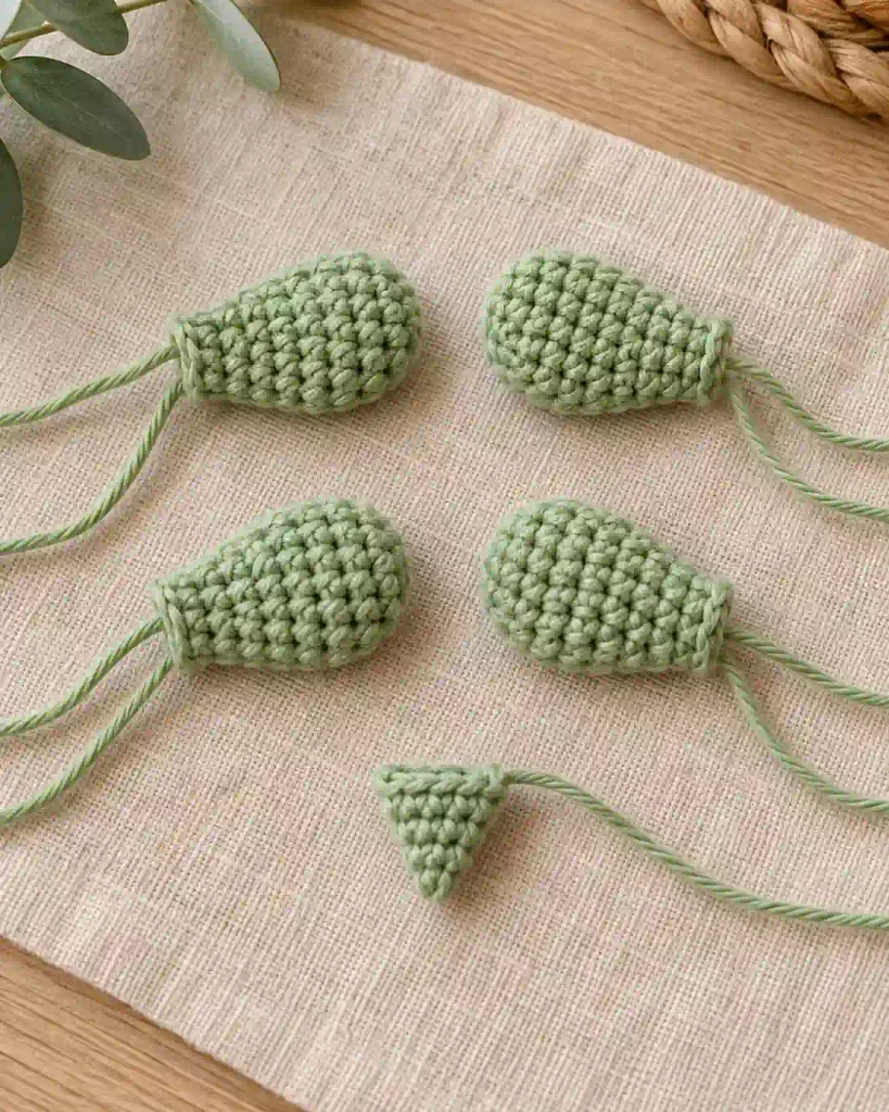 Mini Crochet Turtle Pattern components showing four light green cro