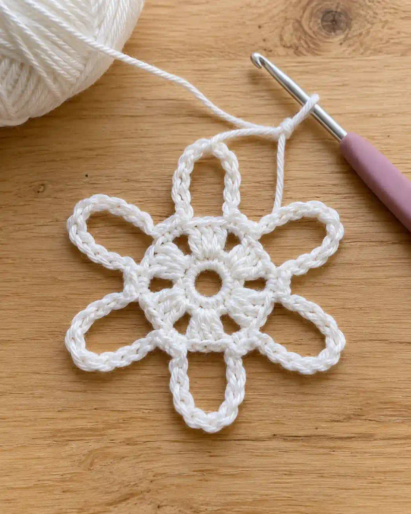 Round 2 expands the center of the Crochet Snowflake Ornament Pattern